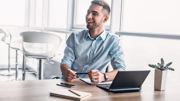 An image showing a young man in an office