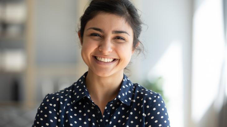 A young woman smiles for a photograph